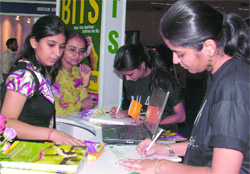 Students check out a stall at the two-day education fair, 7th Infra Educa 2009, at Pragati Maidan in New Delhi on Saturday.