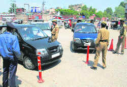 Policemen stop vehicles during a strike called by the Hurriyat Conference against the visit of Vice-President Hamid Ansari in Srinagar on Saturday.