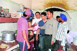 Association members inspect the kitchen of an IRCTC-run canteen.