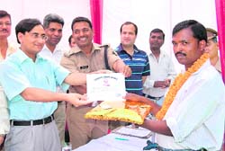 Abdul Qayoom being awarded by DM Amit Negi. 