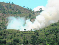 A forest fire near the Drang area of Mandi district presents a rare combination of smoke and clouds. The clouds are in the background. Such scenes are common these days all over Himachal. 