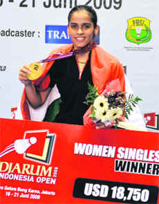 Saina Nehwal holds her gold medal after defeating Lin Wang in Jakarta on Sunday.