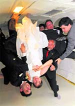 WEIGHTLESS WEDDING: Bride Erin Finnegan and bridegroom Noah Fulmor, both of New York, are helped by the rest of the wedding party as they float upside down during the first weightless wedding aboard a specially-equipped Boeing 727, while flying over the Gulf of Mexico on Saturday. 