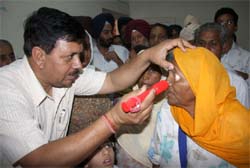 A doctor examining a patient at a free eye check-up camp organised at the Civil Hospital in Bathinda on Monday.