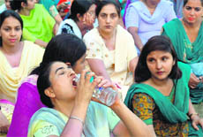 Teachers sit on dharna during a protest at Sector 20, Chandigarh, on Monday.