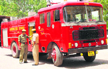 Two firemen inspect an engine in Hisar.