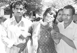 Relatives mourning for those who died in an accident near Kunal Pathri temple at Dharamsala on Monday.
