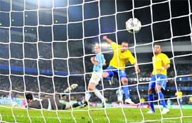 Brazils Luis Fabiano scores the first goal against Italy on Sunday in Pretoria.