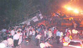 People gather around the bus that slipped off the road into a 20-25 feet deep trench near the Akshardham Temple in east Delhi.