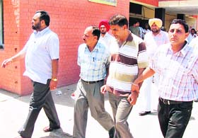 Punjab State Electricity Board accountant Inderjit Kumar being taken away by a vigilance team in Jagroan