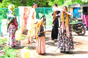 A woman quenches her thirst on a hot Wednesday afternoon