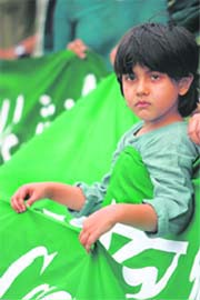 A child holds part of a banner during a human chain formed to express solidarity with Iranians protesting against their country's disputed presidential election, in Dhaka on Wednesday. 