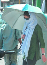 A girl takes all possible precautions to save herself from the scorching heat in New Delhi on Thursday.