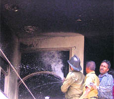 Firemen douse flames at Rajan Bistar Bhandar in Ludhiana on Thursday.