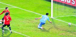 Spanish defender Carlos Puyol (5), Sergio Ramos (15) and goalkeeper Iker Casillas fail to stop a shot by Clint Dempsey during their semifinal against USA on Wednesday.