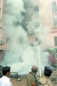 Firemen attend to a minor fire that broke out at the basement of Krishi Bhavan in New Delhi