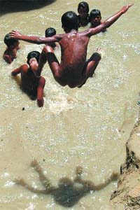 WASHING SWEAT: Children play in the Yamuna in New Delhi