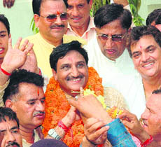 Uttarakhand Chief Minister designate Ramesh Pokhriyal 'Nishank' greets his supporters in Dehradun.