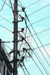 Worn-out wires on an electricity pole in Jammu