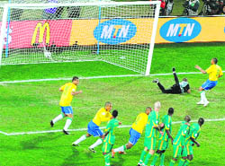 South African goalkeeper Itumeleng Khune fails to stop a shot by Brazils Daniel Alves on Thursday.