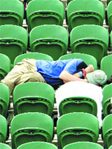 A spectator rests between matches on court two at the Wimbledon tennis championships, in London on Friday