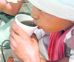 A boy sips a softdrink after seeking alms in the name of ‘Shani’ on a hot afternoon in Chandigarh on Saturday.