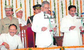Ramesh Pokhriyal Nishank(right) being administered oath of office by Governor BL Joshi at the Raj Bhawan in Dehradun on Saturday. Seen on the left is former Chief Minister BC Khanduri.