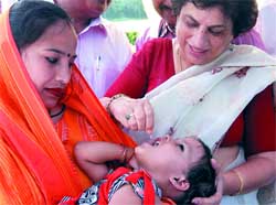 Delhi health minister Kiran Walia gives polio drops in New Delhi on Saturday.