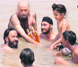 Innovative Idea: Sick of the scorching heat, residents cool beer bottles in the Sidhwan Canal in Ludhiana on Sunday.