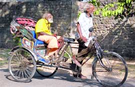 These two old men draw solace from each other while braving the summer wave on a city road.
