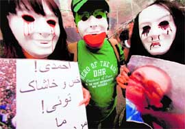 Iranian residents in Japan hold placards during a rally against the results of the presidential election in Iran in Tokyo on Sunday.