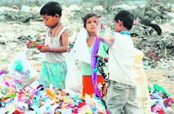 Children pick up rags in a Panipat textile factory