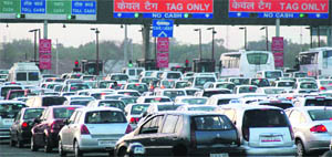 A large number of vehicles, including cars, stuck in a traffic jam at the toll plaza on the Gurgaon-Delhi border.