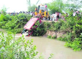 A crane is used to pull out a mangled Tavera which fell into the Bist Doab canal near Hoshiarpur