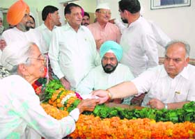A woman hands over a chit with a request to Mohinder Singh Kapyee soon after he took over as PPCC chief in Chandigarh