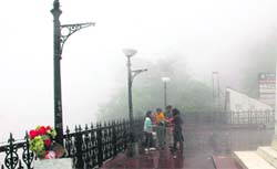 A group of tourists is making most of the rain on the Ridge at Shimla