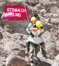 A soldier practising a difficult drill to bring down a colleague on his shoulder at the Kargil Battle School on the Drass-Zojila Highway.