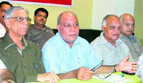 Small-scale traders discuss government policies in Ludhiana on Tuesday.