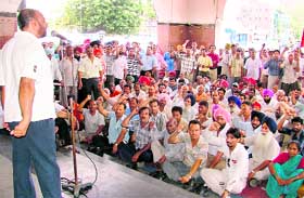 A trade union leader lists the demands of railway employees at a rally in Ludhiana on Tuesday.