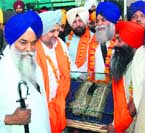 The holy Kalgi of Guru Gobind Singh arrives at the Rajasansi International Airport in Amritsar on Tuesday.