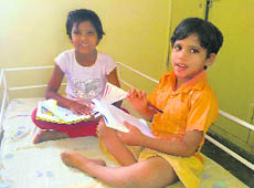 Pooja and Chanda revise their lessons in their room at Bal Gram, Rai, Sonepat, before the school reopens. 