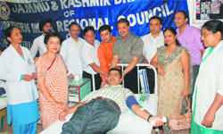 A volunteer donates blood during a camp at Government Medical College and Hospital, Jammu, on Wednesday. 