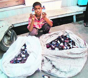 A boy with cough syrup bottles collected from various places at Machhiwara