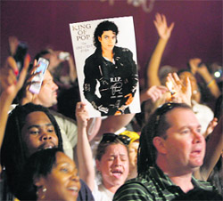 Fans attend the Michael Jackson public memorial at the Apollo Theatre in New York on Tuesday. 