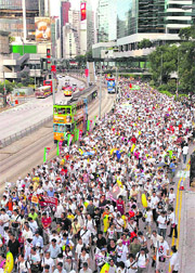 Thousands of pro-democracy protesters take to the street during a demonstration demanding universal suffrage in Hong Kong on Wednesday. The day marked the 12th anniversary of the territorys handover to China from Britain.