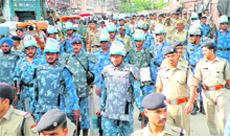 Rapid Action Force personnel along with local police take out a flag march ahead of Kanwar Mela in Haridwar on Thursday. 