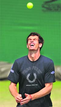 Andy Murray bounces a tennis ball on his head during a training session