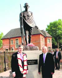 British Prime Minister Gordon Brown accompanied by MP Keith Vaz after garlanding the newly installed statue of Mahatma Gandhi at Leicester in UK