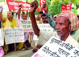Activists of the Communist Party of India (CPI) protest against the oil price hike,in New Delhi on Friday.