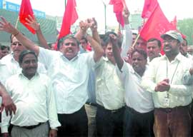 Air India staff protest outside IGI Airport in New Delhi on Friday.